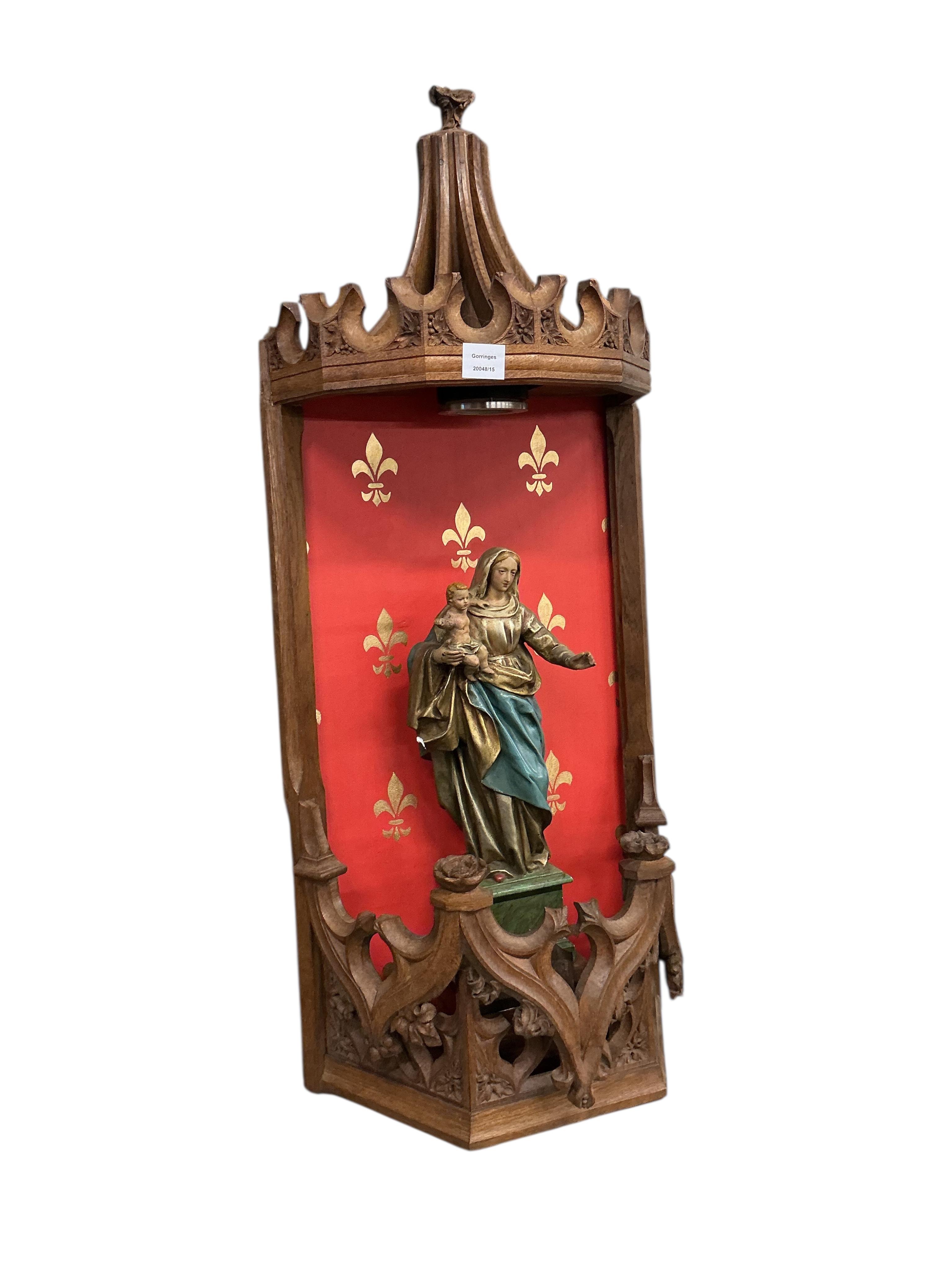 A Gothic Revival carved oak niche with plaster Madonna and child, height 104cm